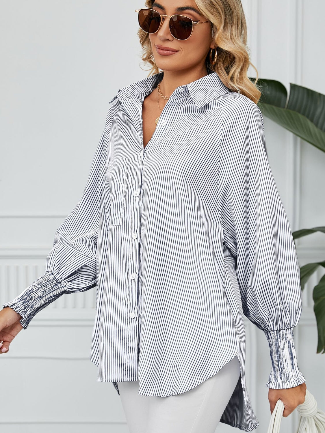 Stripe button-up shirt with balloon sleeves and smocked cuffs.