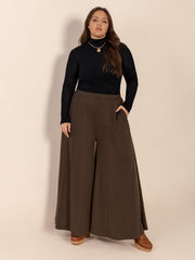 Dark brown sculpted flare palazzo trousers with vertical seam detail and pockets.