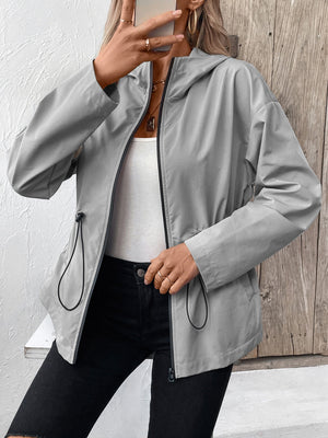 Gray hooded utility jacket with cinched waistline and zip front.