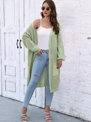 Light Green ribbed knit maxi cardigan with pockets and balloon sleeves, styled with a white cami and jeans.