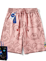 Pink men's shorts with all-over bear print and drawstring waist.