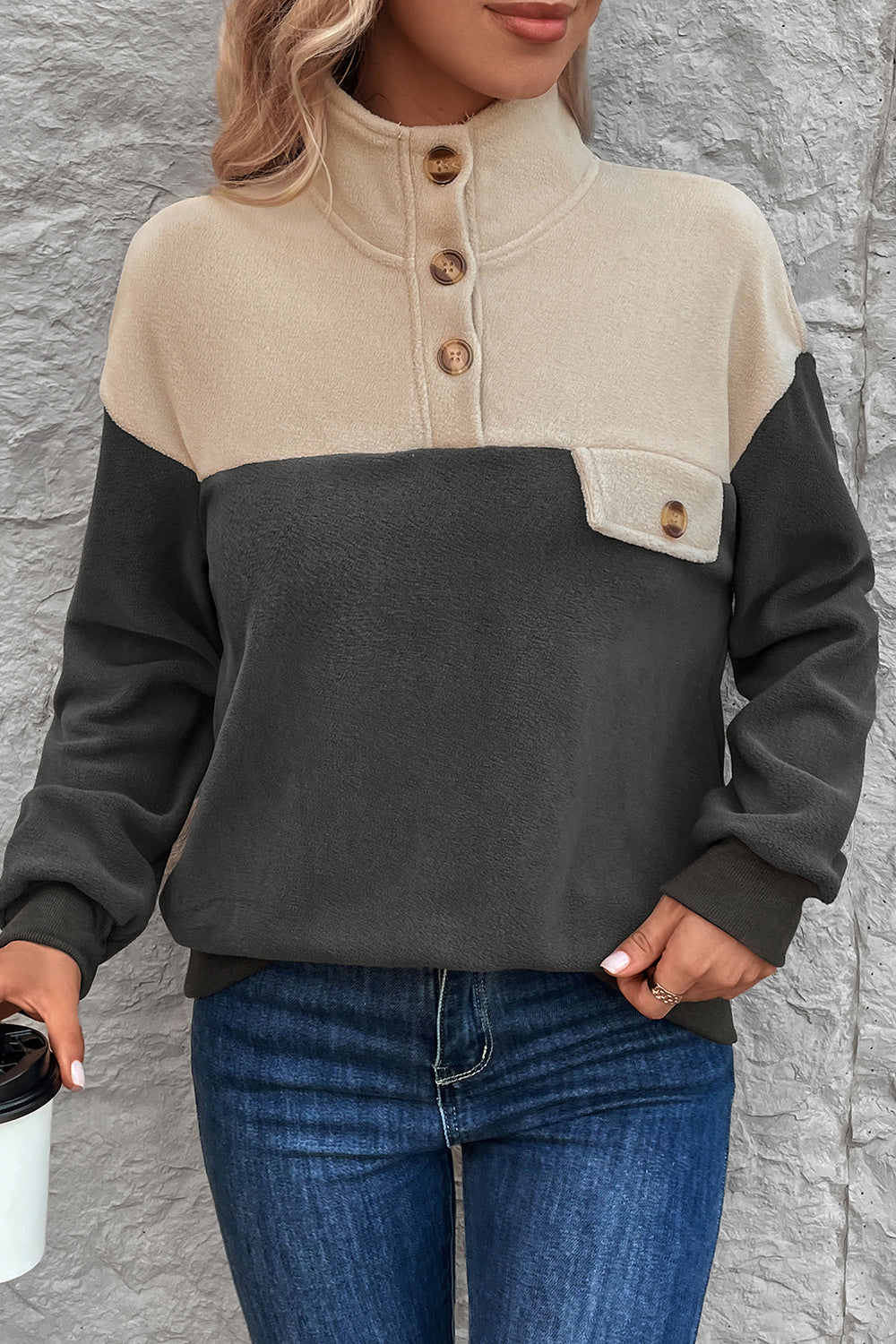 Colorblock fleece pullover with button-up neckline and chest pocket in dark gray and beige.
