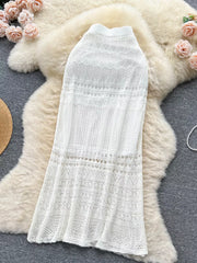 White openwork maxi skirt with intricate knit patterns and a flowing silhouette.