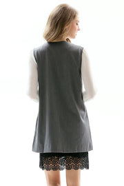 Mid gray tailored sleeveless vest with single button, worn over a white blouse and black lace trim.