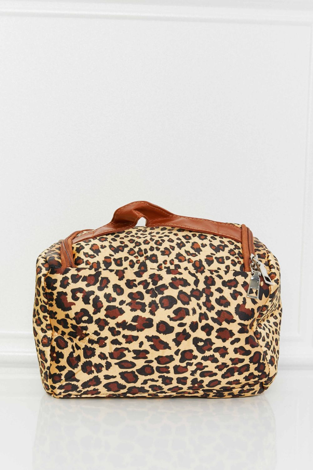 Leopard print travel organizer bag with brown trim and handle.