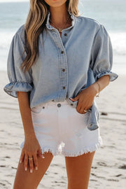 Light blue denim blouse with ruffled collar and puff sleeves, button front, casual style
