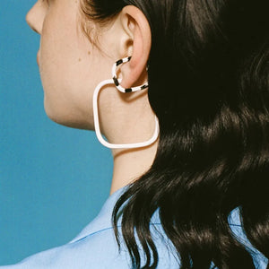 Geometric zebra stripe ear cuffs with a square shape and bold black and white pattern.