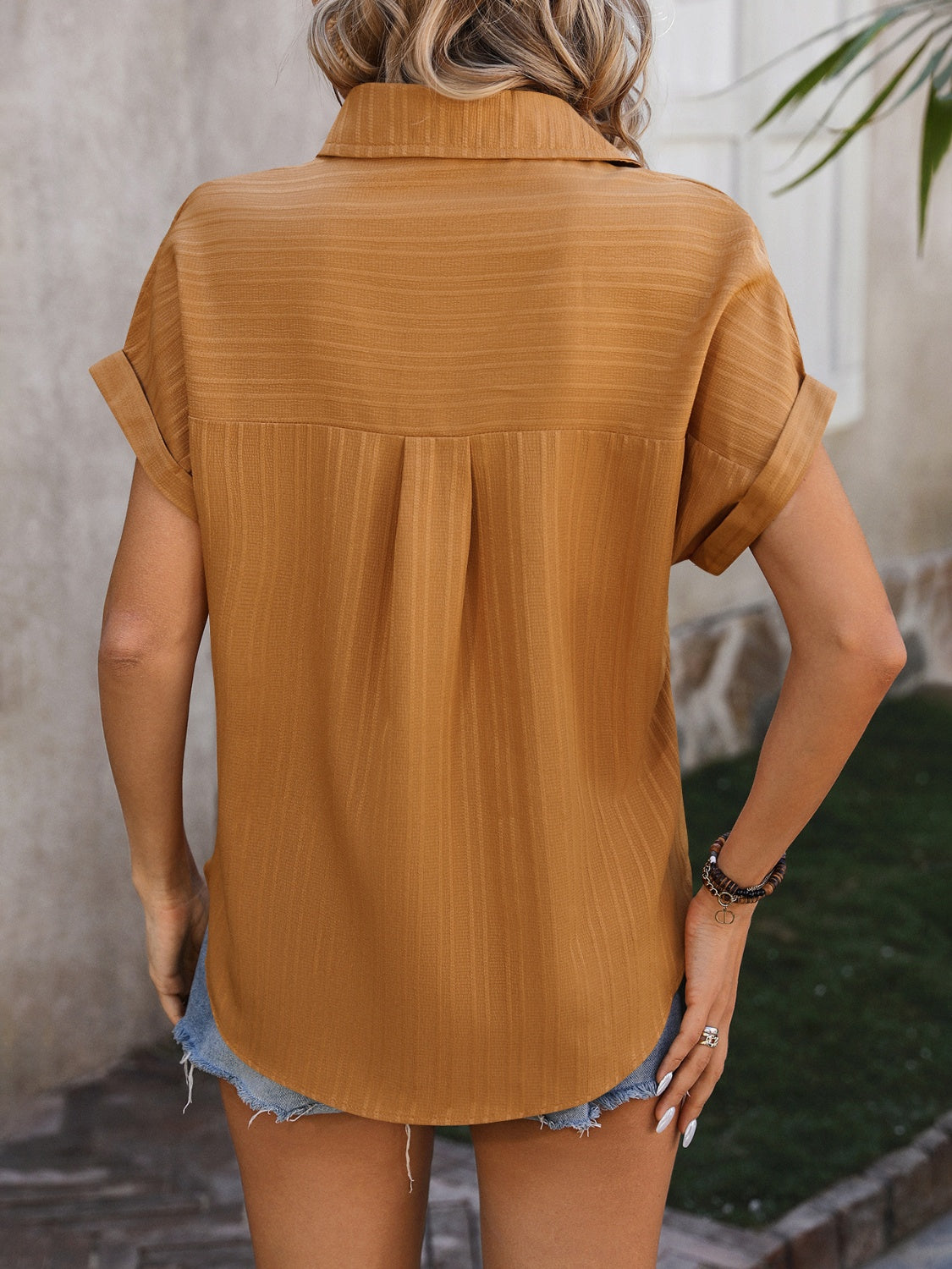 Mustard textured button-down shirt with cuffed sleeves and a pleat detail on the back.