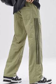 Light green sweatpants with side stripes and pockets