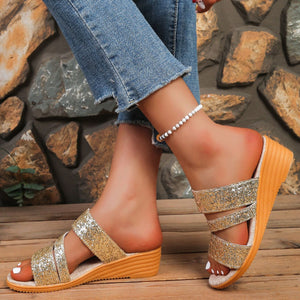 Gold sequined wedge sandals with double straps and wooden wedge heel.