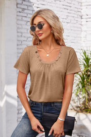 Mocha gathered yoke top with button trim and short sleeves.