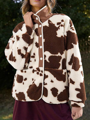 Cow print sherpa button-up jacket with brown trim and white buttons.