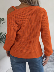 Pumpkin one-shoulder knit sweater with buckle detail and asymmetrical neckline, 100% acrylic.