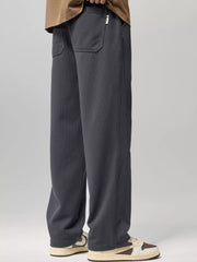 Relaxed fit gray drawstring sweatpants with back pockets and subtle vertical texture.