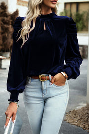 Navy velvet keyhole blouse with puff sleeves and smocked cuffs.