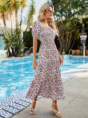 Shirred bodice paisley midi dress with puff sleeves and tiered skirt in red-violet.
