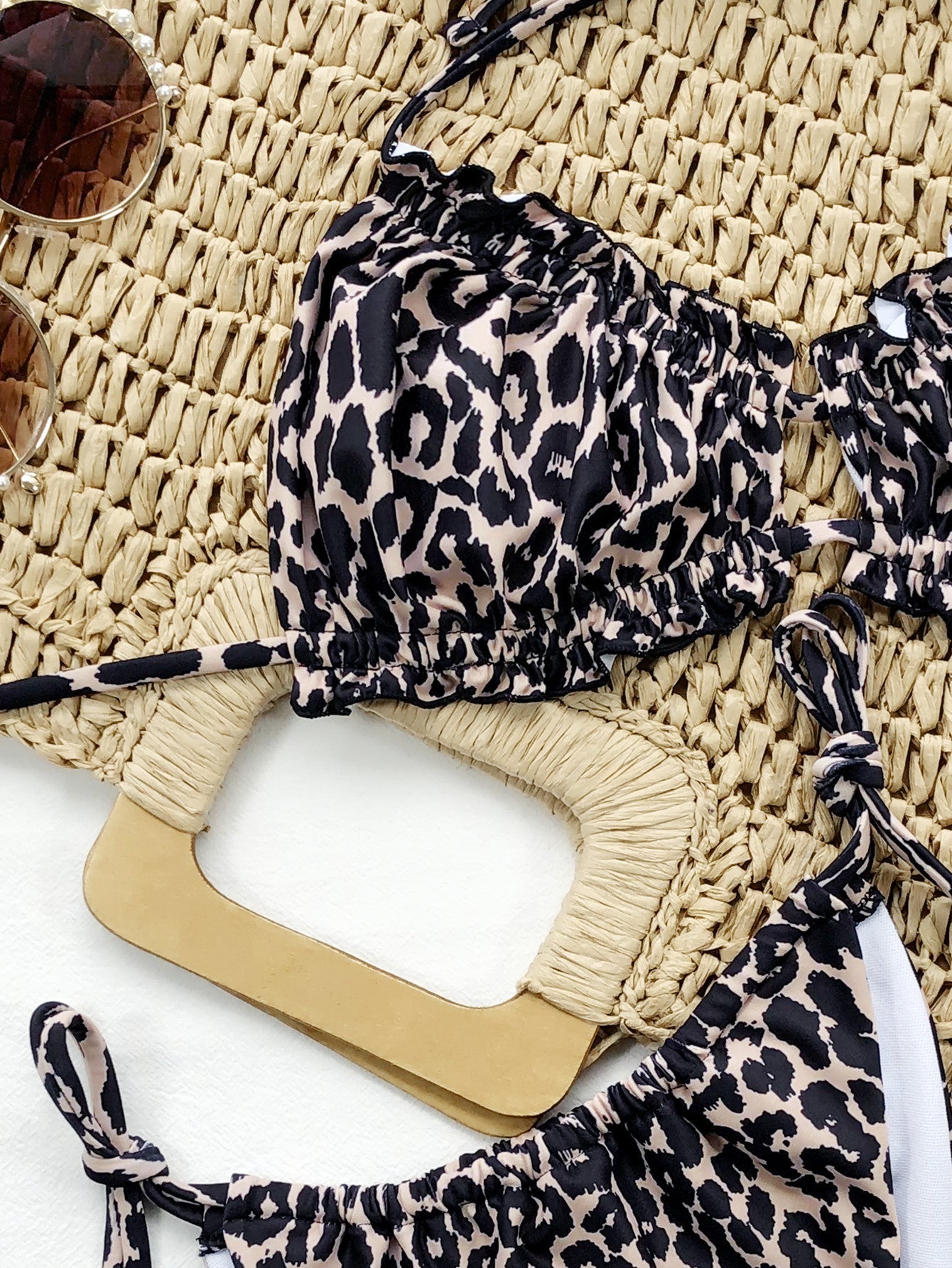 Leopard print bikini set with ruffled cups and tie details.