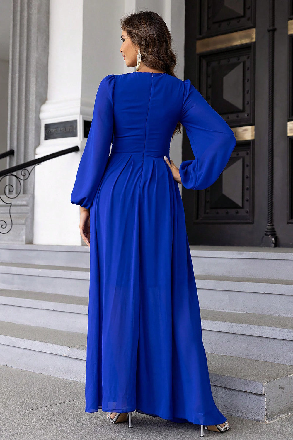 Royal blue maxi dress with long balloon sleeves and a pleated skirt.