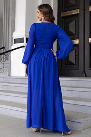 Royal blue maxi dress with long balloon sleeves and a pleated skirt.