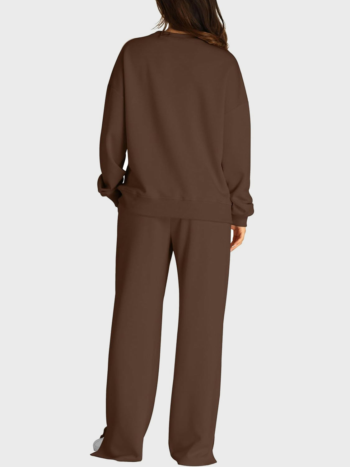Brown seamed loungewear set with crewneck sweatshirt and slit-front wide-leg trousers.