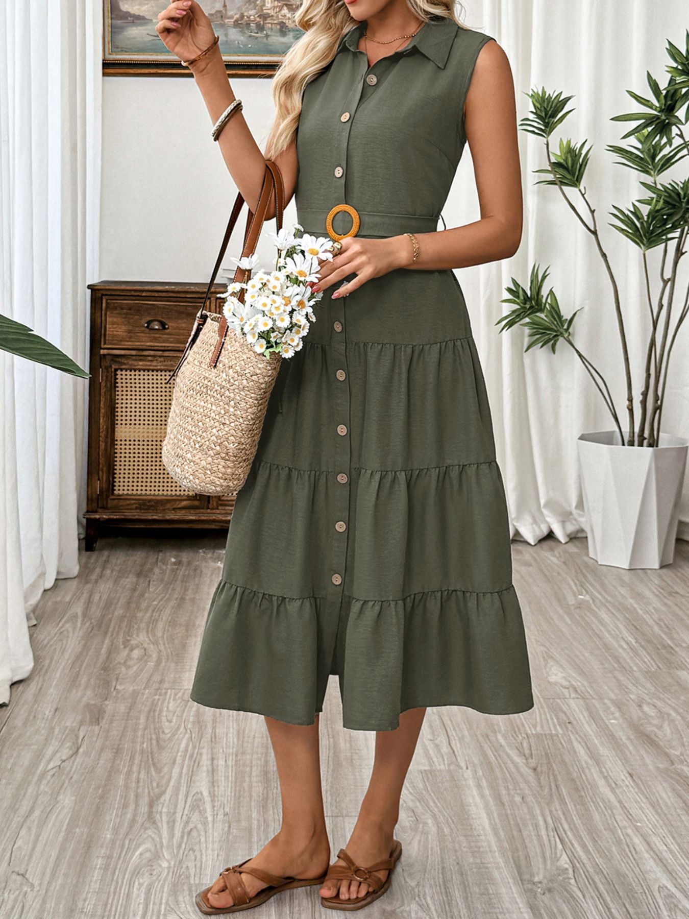 Sleeveless green button-down midi dress with tiered skirt and belted waist.