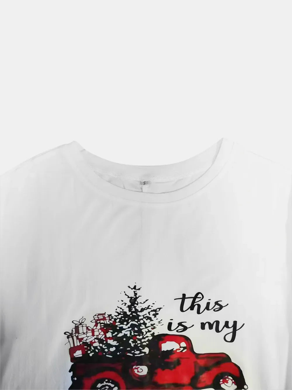 White graphic tunic dress with red truck, Christmas tree, and gifts print.