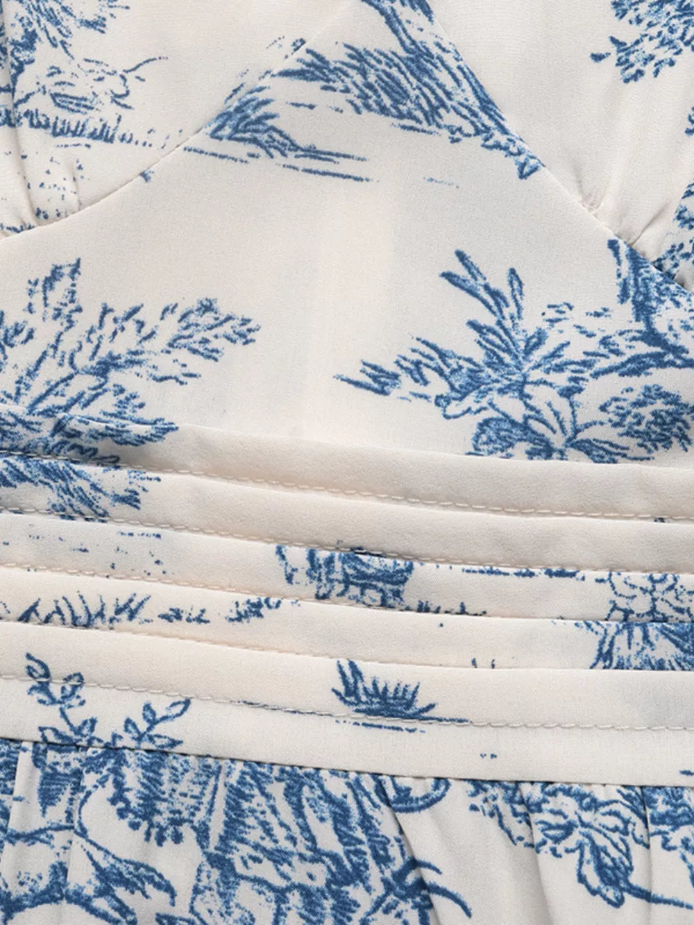 Toile print midi dress with blue scenic pattern, V-neck, and ruched waist detail.