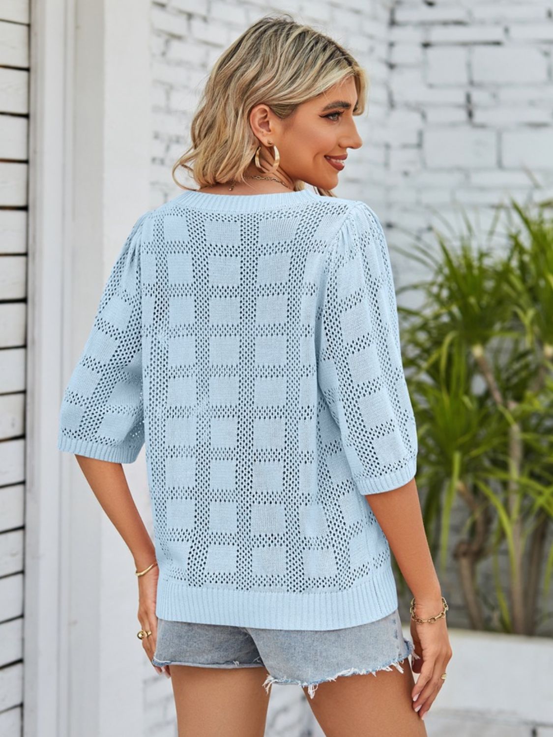 Light blue openwork box stitch knit top with puff sleeves and a relaxed fit.