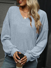 Light blue textured ribbed v-neck blouson sleeve top with cuffed sleeves.