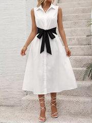 White midi shirt dress with black bow tie belt, button front, and sleeveless design.