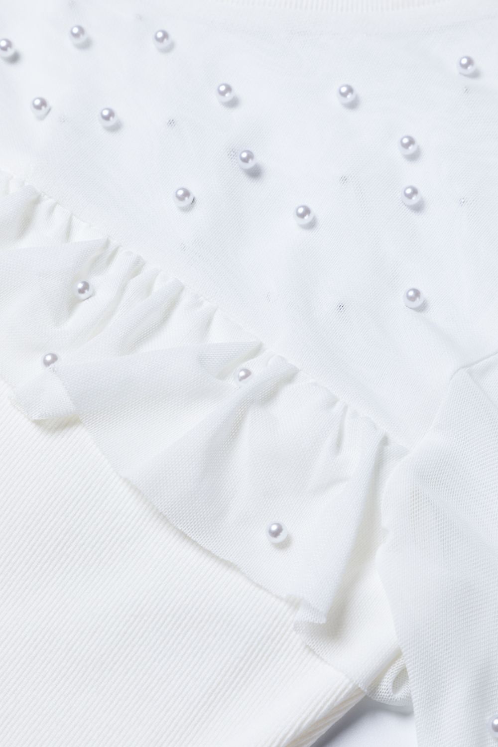 White mesh yoke bodysuit with pearl embellishments and ruffled trim