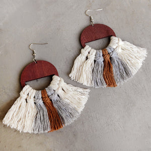 Geometric macrame tassel earrings with wood half-circle detail in cream, grey, and brown.