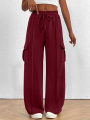 Burgundy high waist cargo sweatpants with drawstring and side pockets.