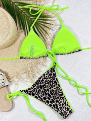 Leopard print tie-side bikini set with neon green straps and trim.