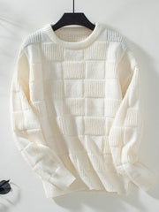 Cream textured checkerboard knit pullover sweater with crewneck and long sleeves.