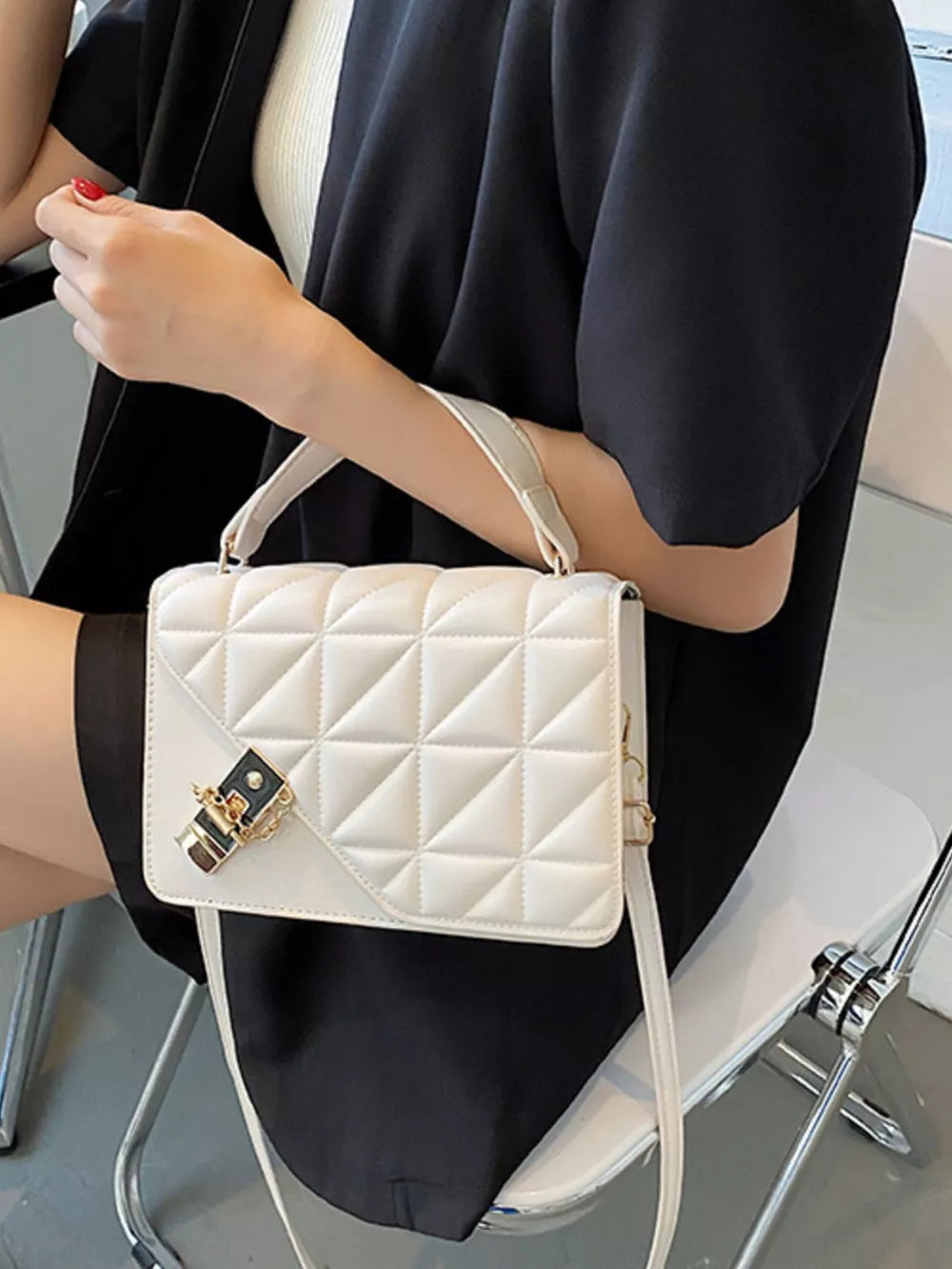 Diamond quilted PU leather crossbody bag in beige white with gold hardware and turn-lock closure.
