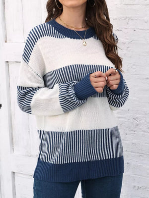 Cozy color block knit sweater with blue and white stripes, crew neck, and long sleeves.