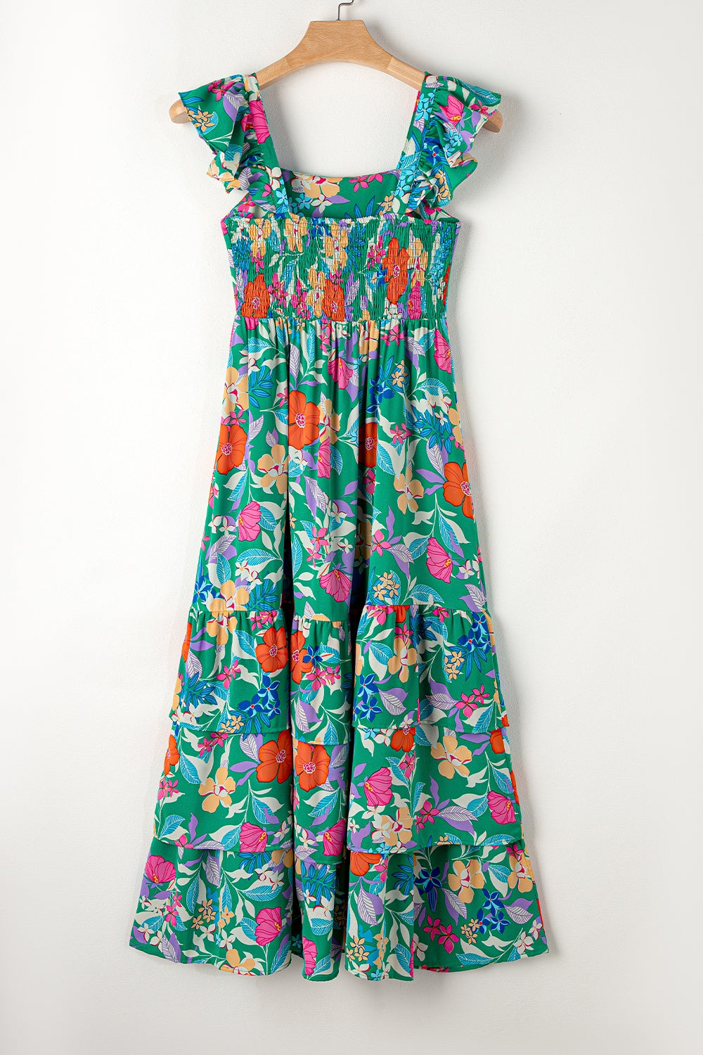 Green floral tiered midi dress with smocked bodice and ruffle sleeves.