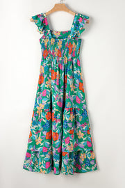 Green floral tiered midi dress with smocked bodice and ruffle sleeves.