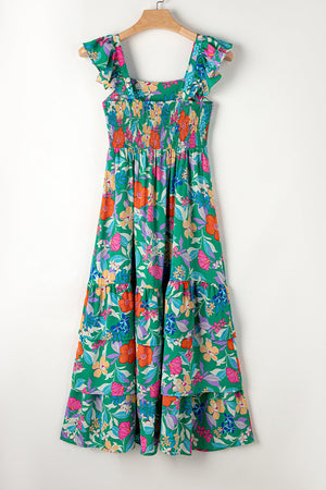 Green floral tiered midi dress with smocked bodice and ruffle sleeves.