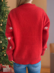 Red acrylic knit sweater with white snowflake pattern on sleeves.