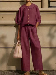 Burgundy two-piece set with button-down top and wide-leg pants, featuring a Peter Pan collar and drawstring waist.