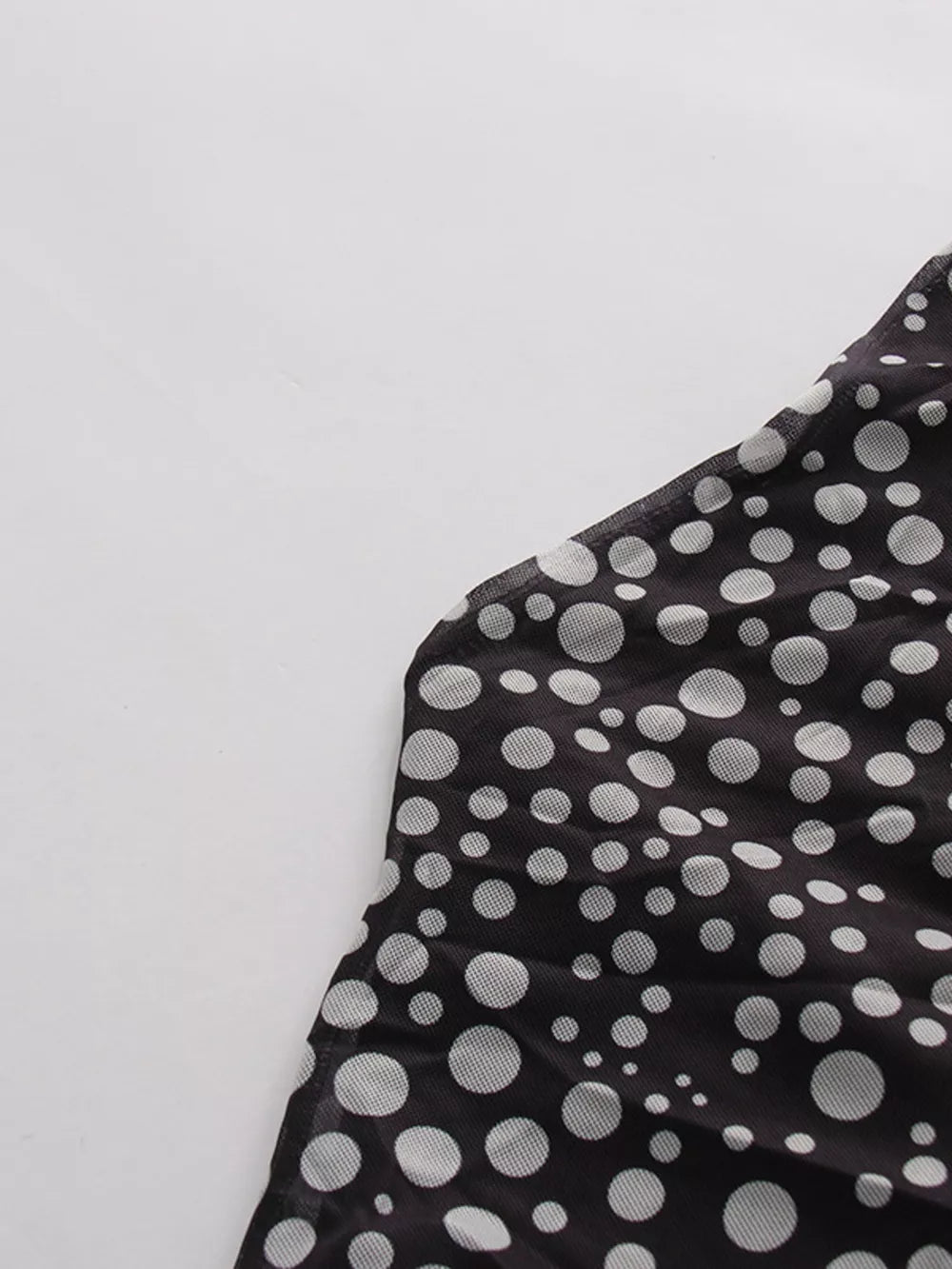 Black mesh maternity maxi dress with white polka dots and halter neckline detail.