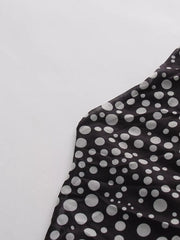 Black mesh maternity maxi dress with white polka dots and halter neckline detail.
