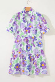 Vibrant floral mini dress with tiered ruffles and short sleeves.