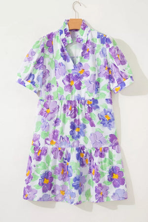 Vibrant floral mini dress with tiered ruffles and short sleeves.
