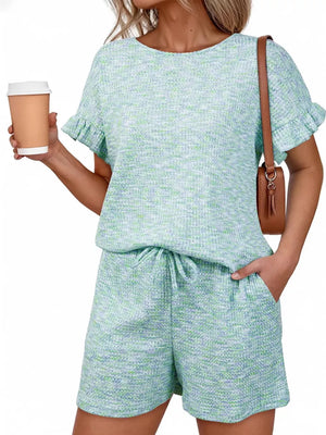 Green and blue marled knit two-piece set with ruffled short sleeves and drawstring shorts.