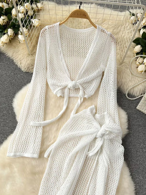 White crochet knit tied crop top and high slit skirt set with long sleeves.