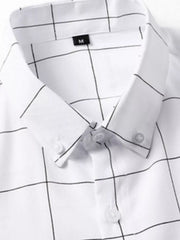 White cotton oversized button-down shirt with black plaid print and button collar.