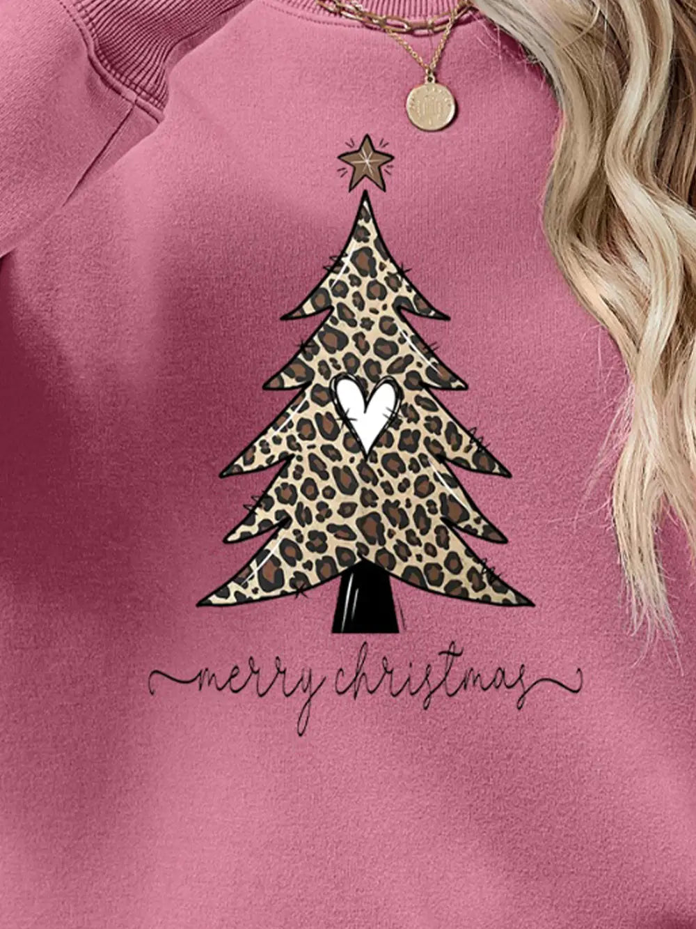 Blush pink sweatshirt with leopard print Christmas tree graphic and Merry Christmas text.